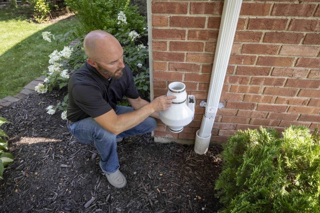 Man Inspecting Radon System Repair
