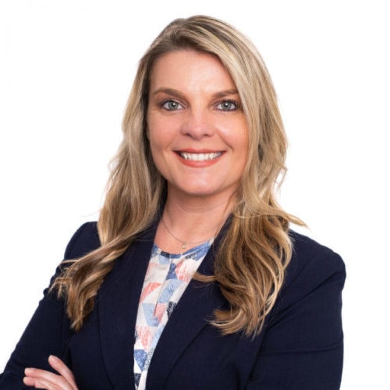 Woman Smiling in Professional Attire for Radon Services Company
