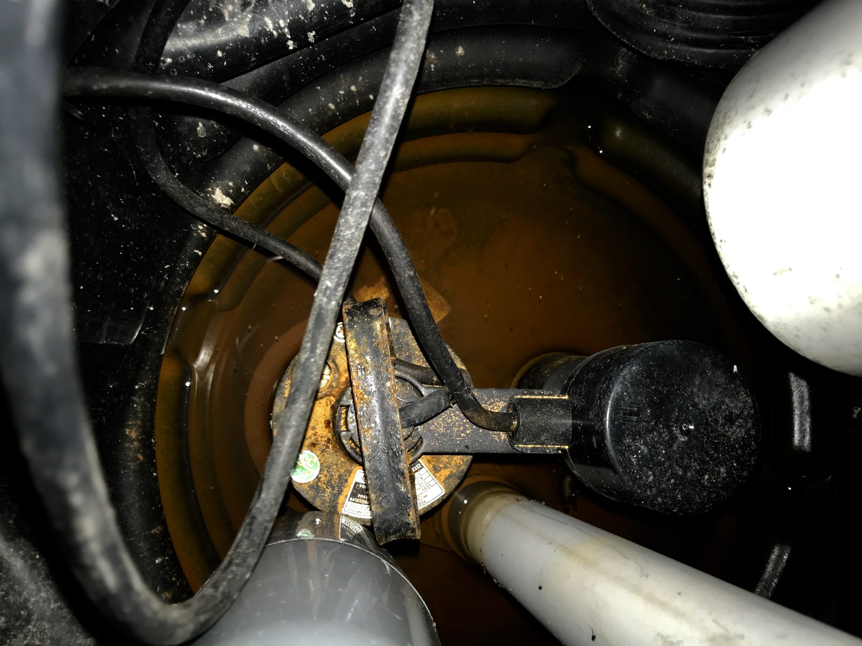 Top View of a Sump Pump Component in Basement